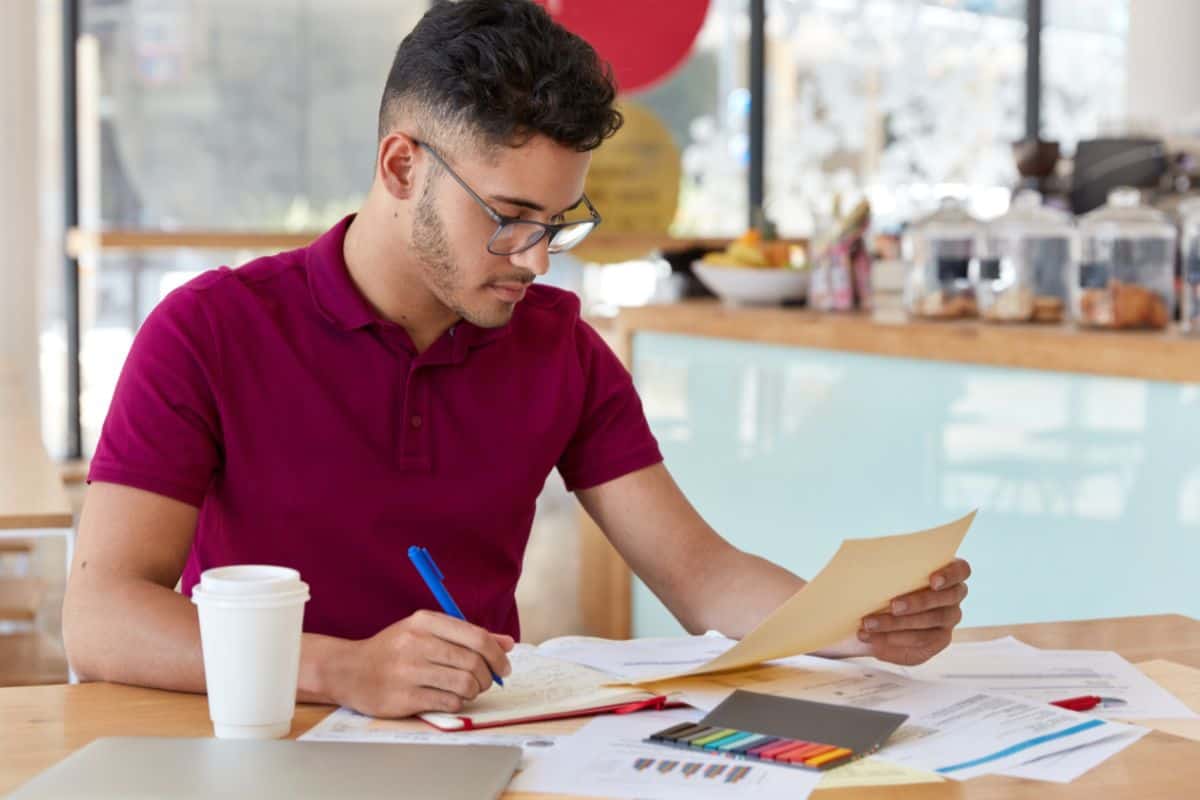 Image of busy unshaven copy writer
