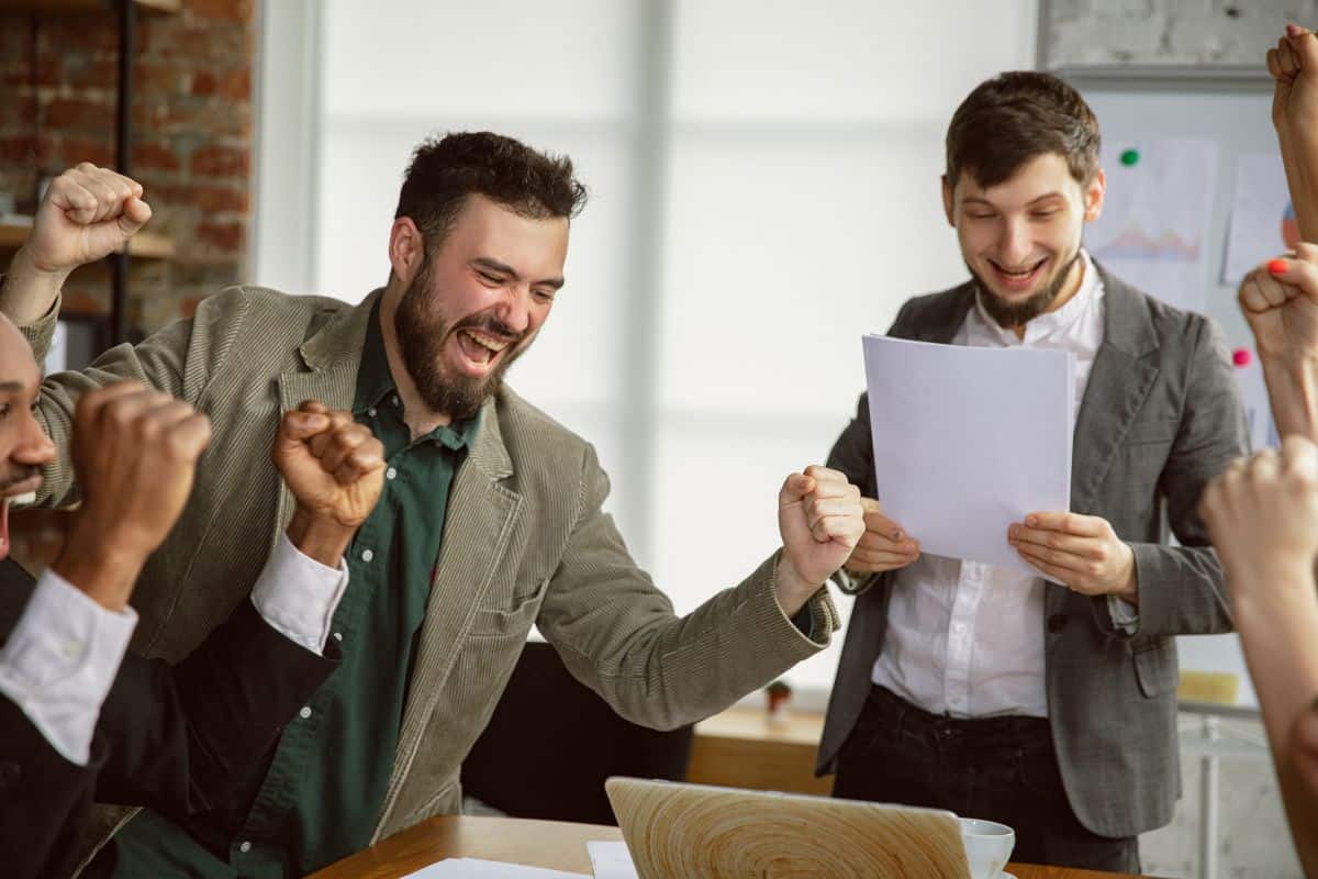 Celebrate success group of young business professionals having a meeting