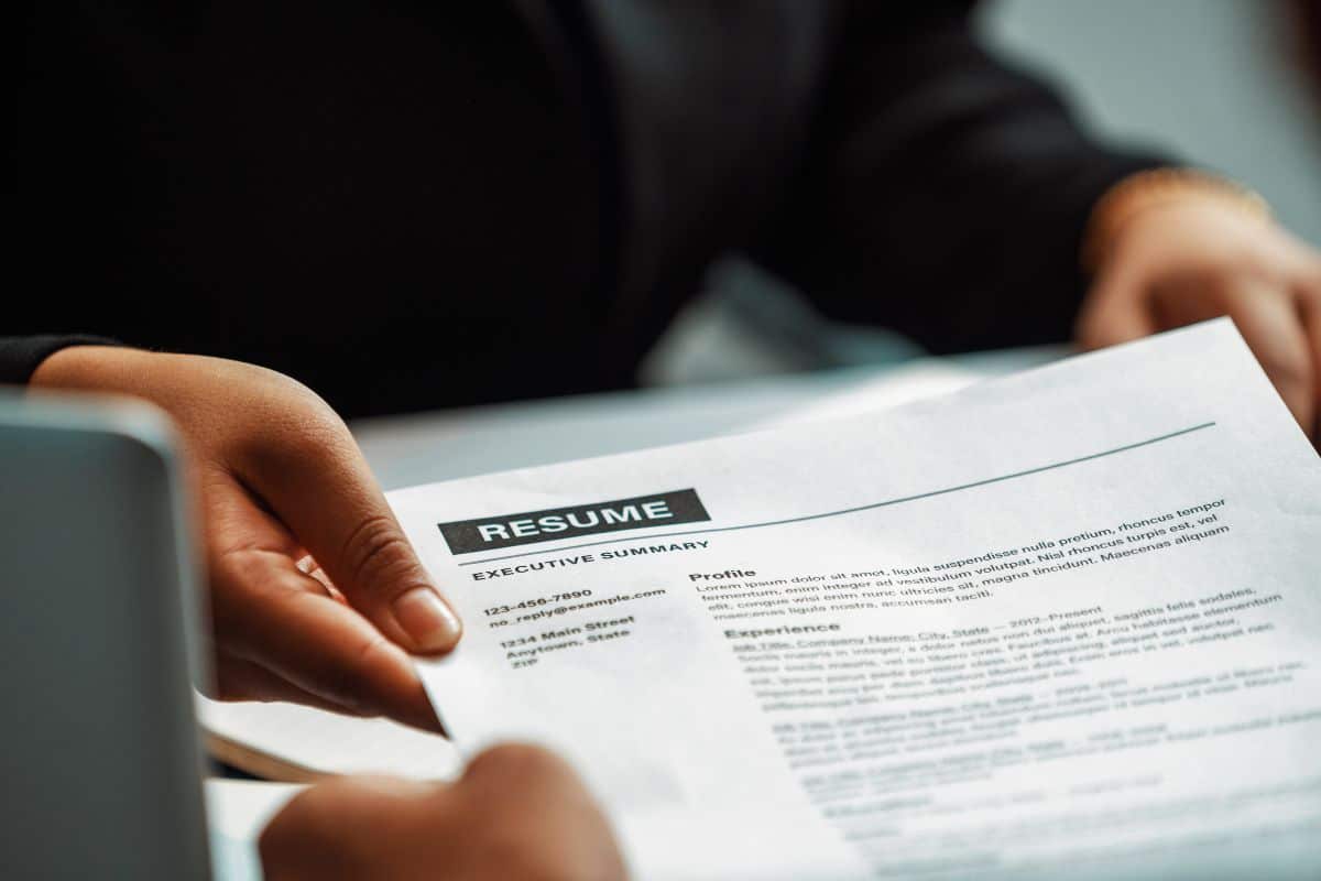 Candidate hands resume to the interviewer uds
