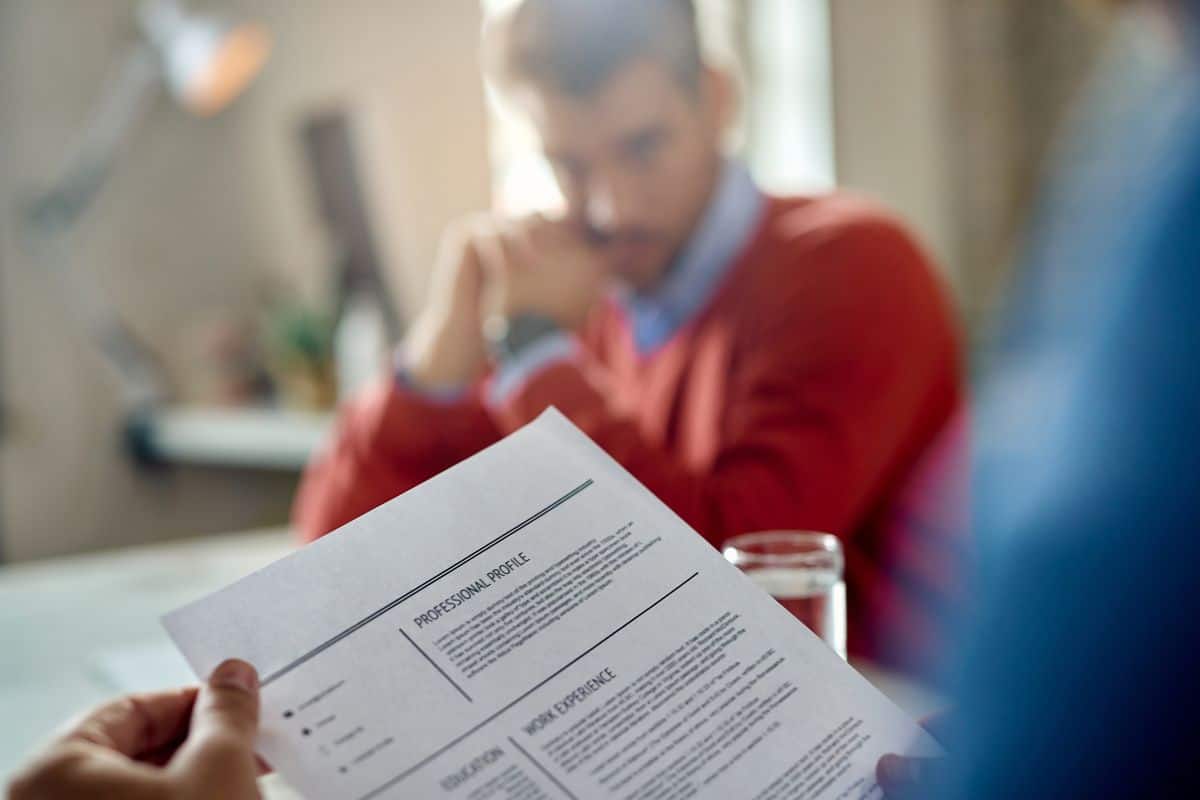 Closeup of a member of human resource teal reading candidate's cv
