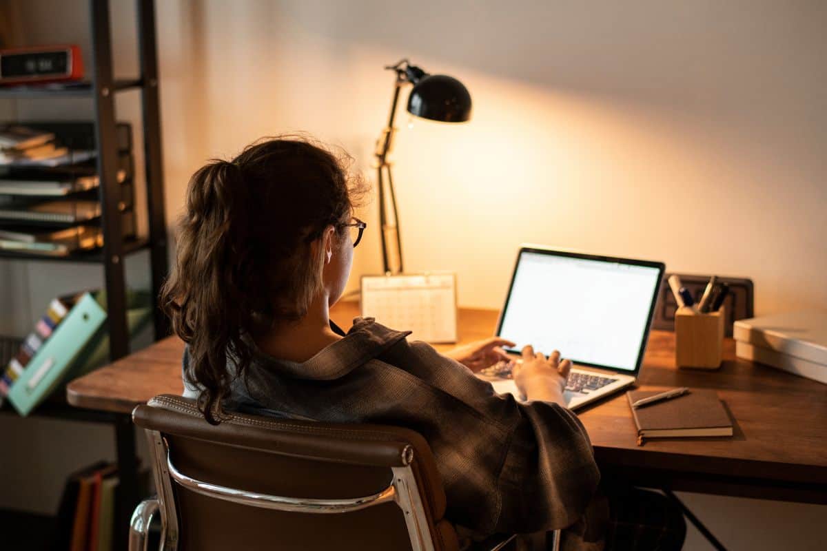 Teen girl doing homework on her laptop