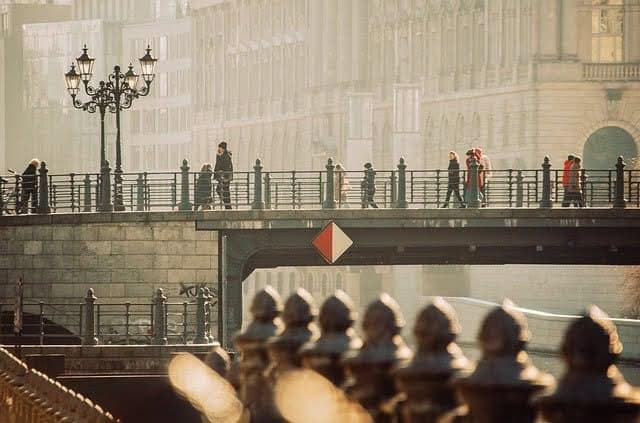 AI-generated image of a bridge with people walking by, capturing an urban or scenic atmosphere