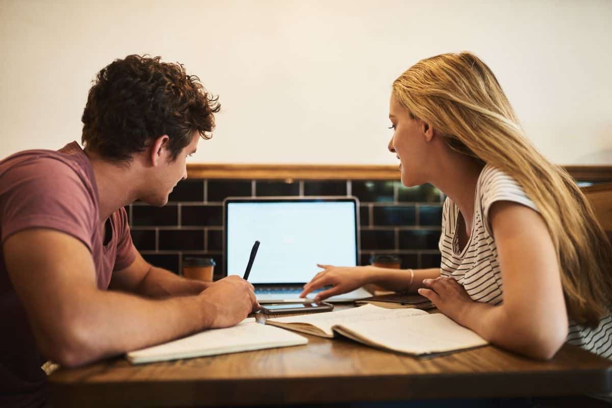 Students laptop and conversation with notebooks