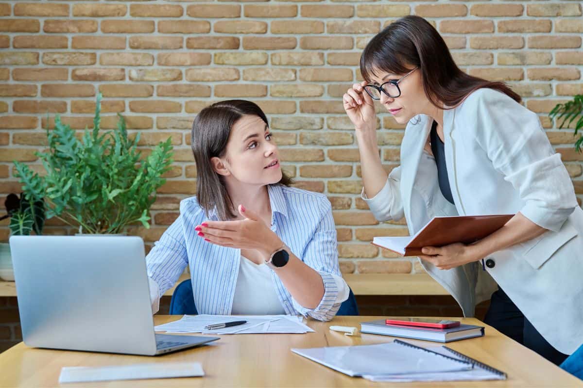 Two businesswomen talking and discussing in office
