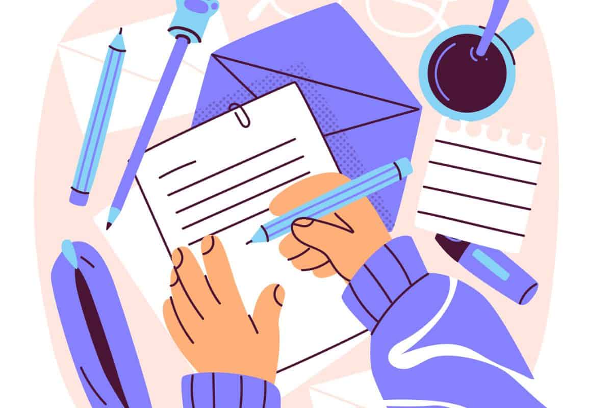 Stock image of a person writing on paper with pens and a highlighter placed to the side