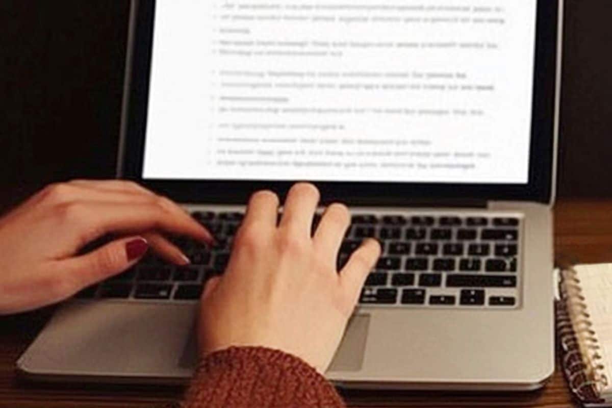 Close up of woman person hands on the laptop computer keyboard