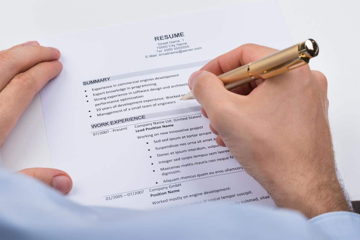 Businessperson with resume and pen