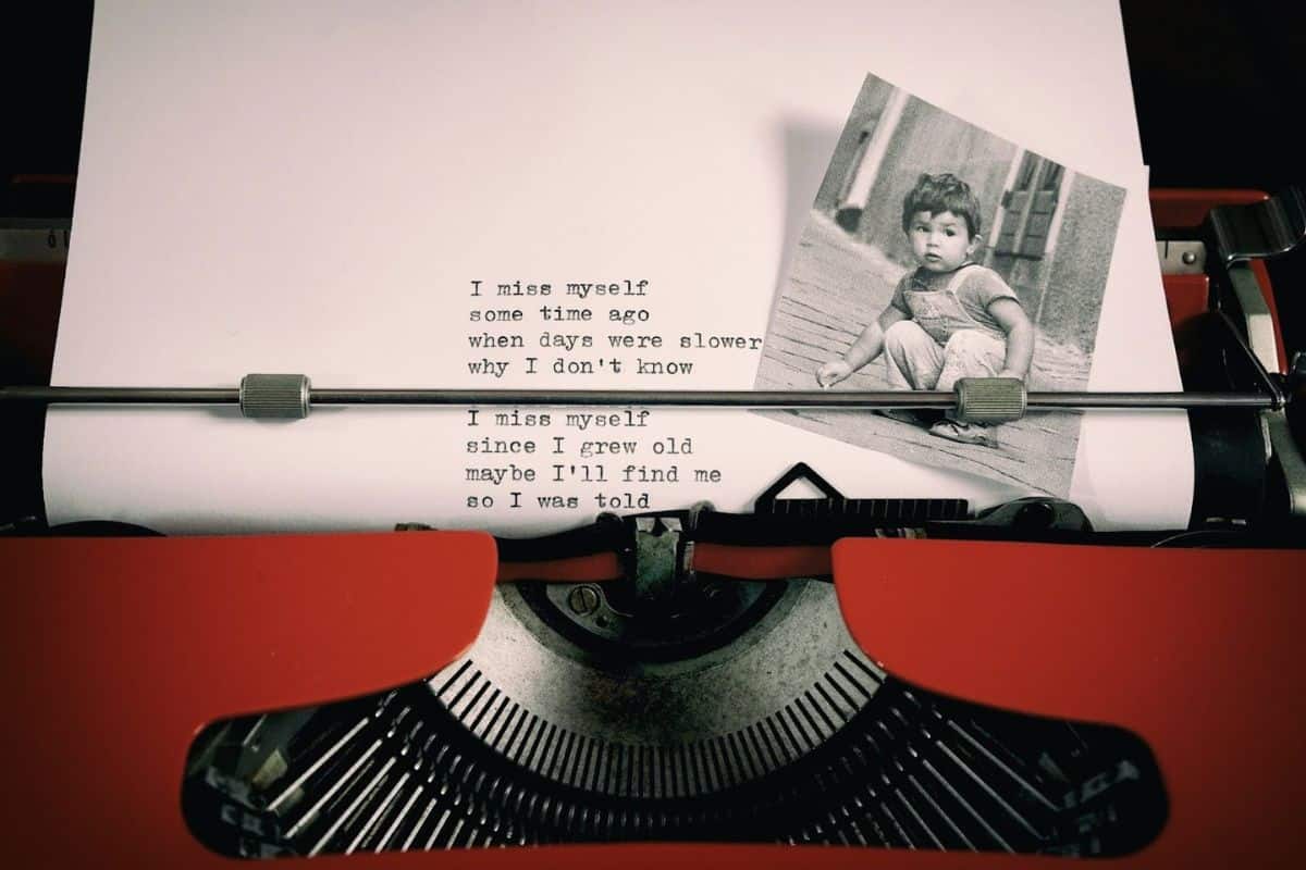 Stock image of a typewriter with a typed poem and a black and white photograph