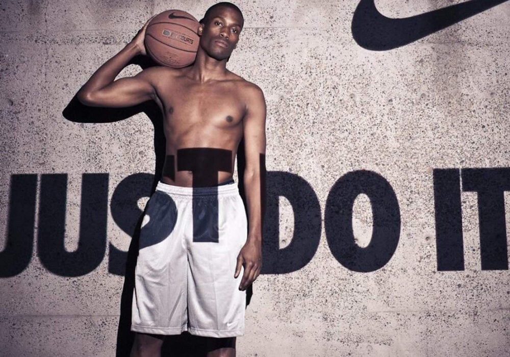Ethos, Pathos, Logos: Definitions and Examples 13 A man holding a ball with the Nike logo and the slogan 'Just Do It' displayed prominently