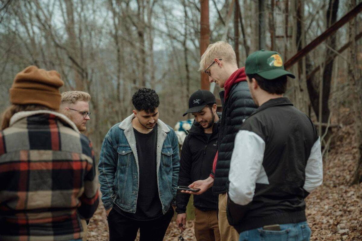 Stock image of young boys exploring and walking through a wooded forest area.