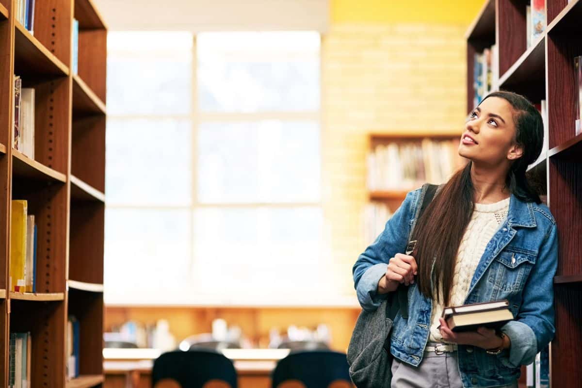 Thinking student and girl with books in library with choice for education