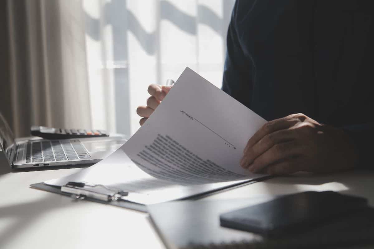 Asian businessman reviewing document reports at office workplace