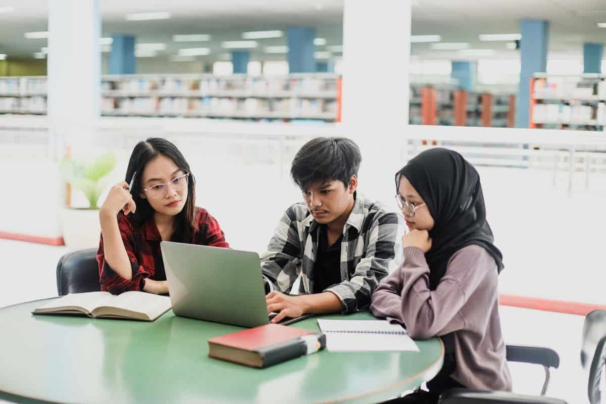 Group of students having discussion to finish assignment