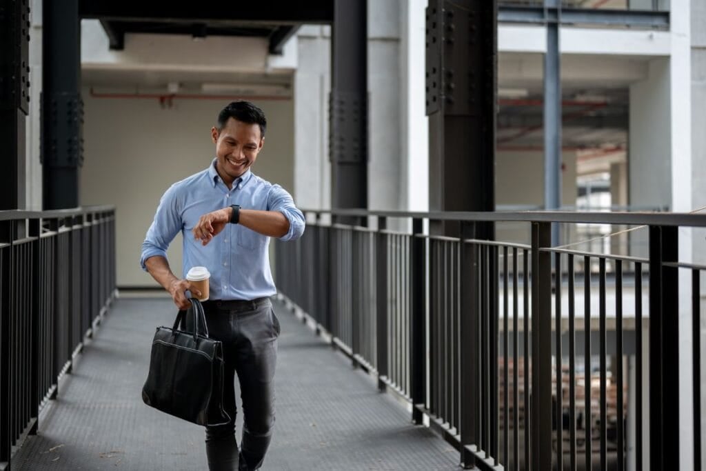 A confident asian businessman is checking time
