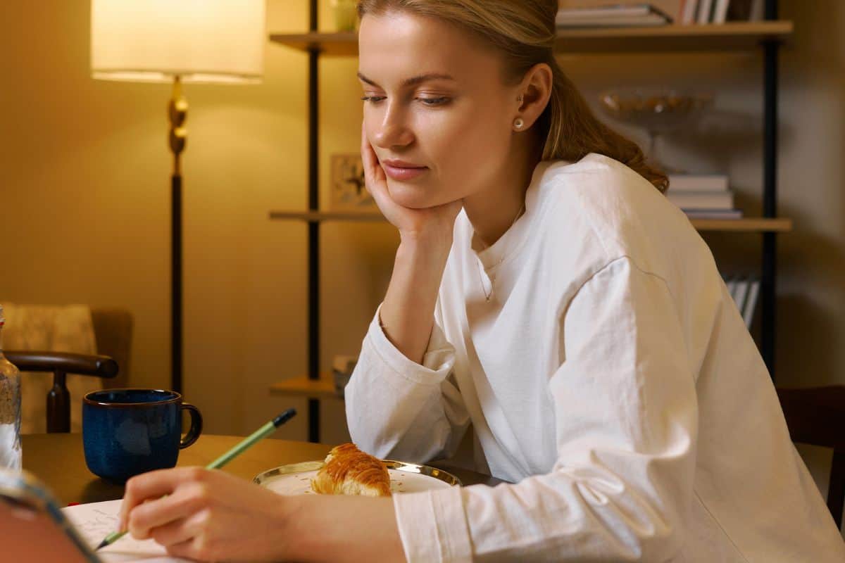 Young woman studying quietly at home in evening atmosphere