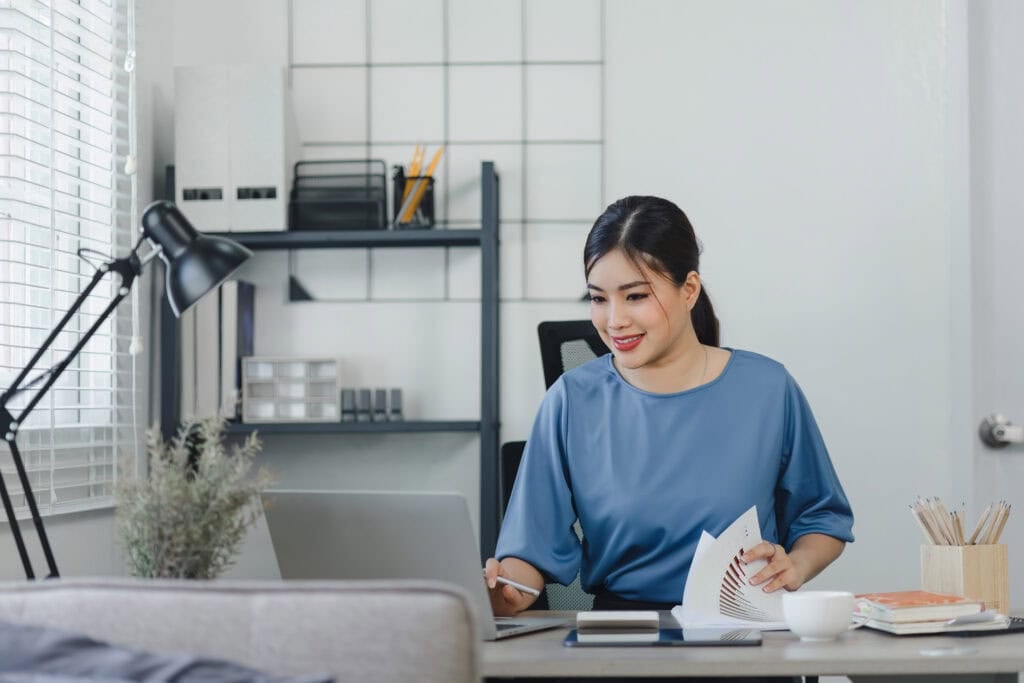 Focused young asian businesswoman sitting
