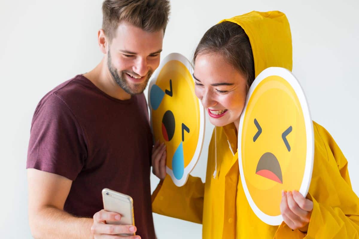 Couple taking selfie with emojis