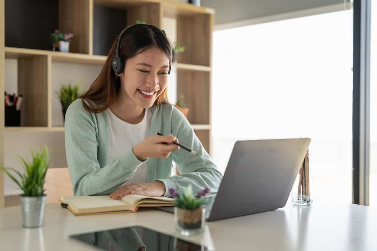Stock image of a student learning online using a laptop