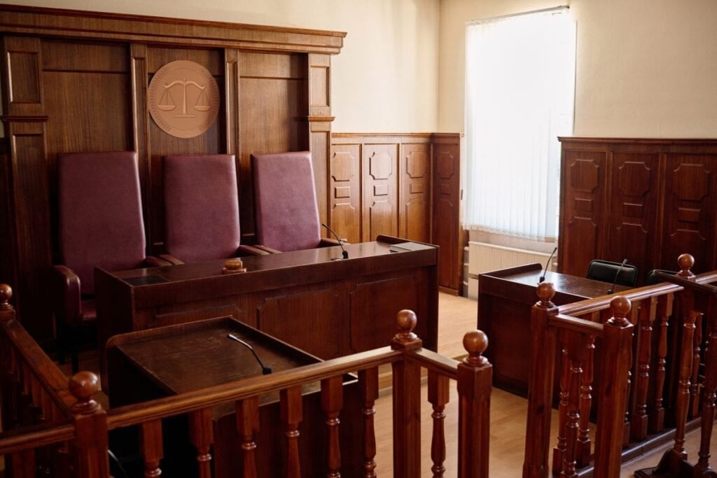 Part of spacious courtroom with wooden furniture 