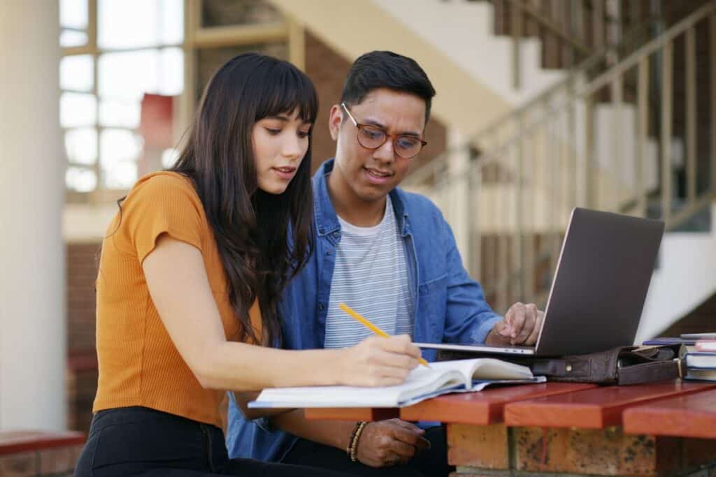 Studying notes and students with books and laptop for learning education