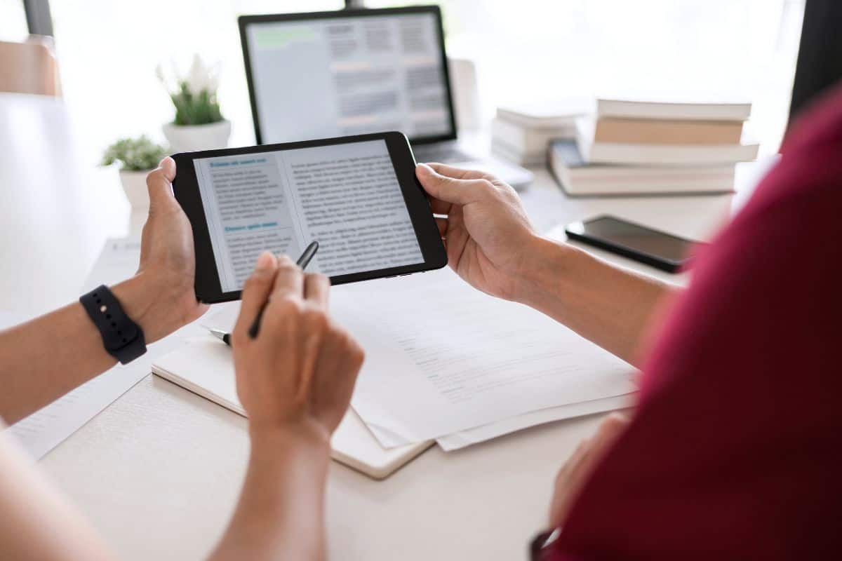 Midsection of woman using laptop on table