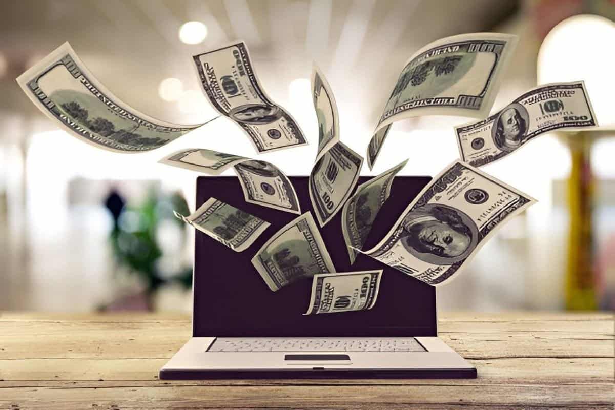 Illustration of dollars flying out from a laptop screen