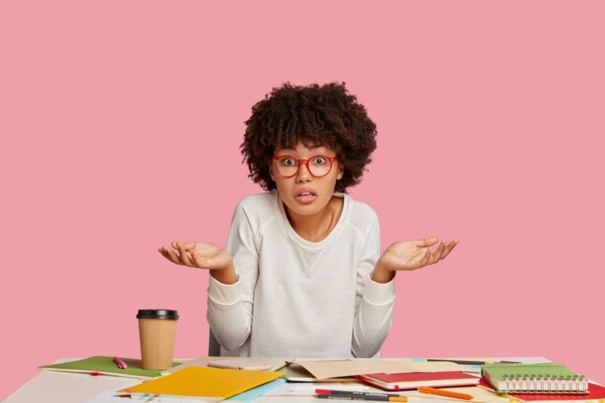 Clueless dark skinned student has hesitant expression