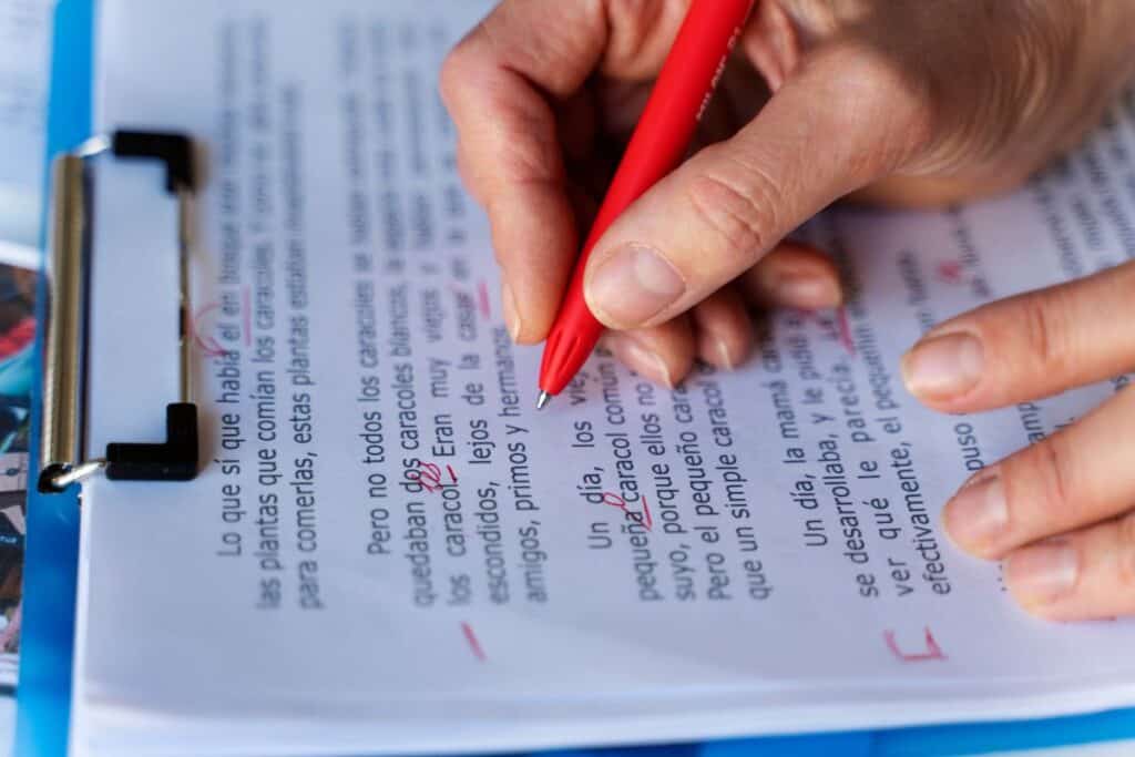 High angle hand correcting grammar mistakes