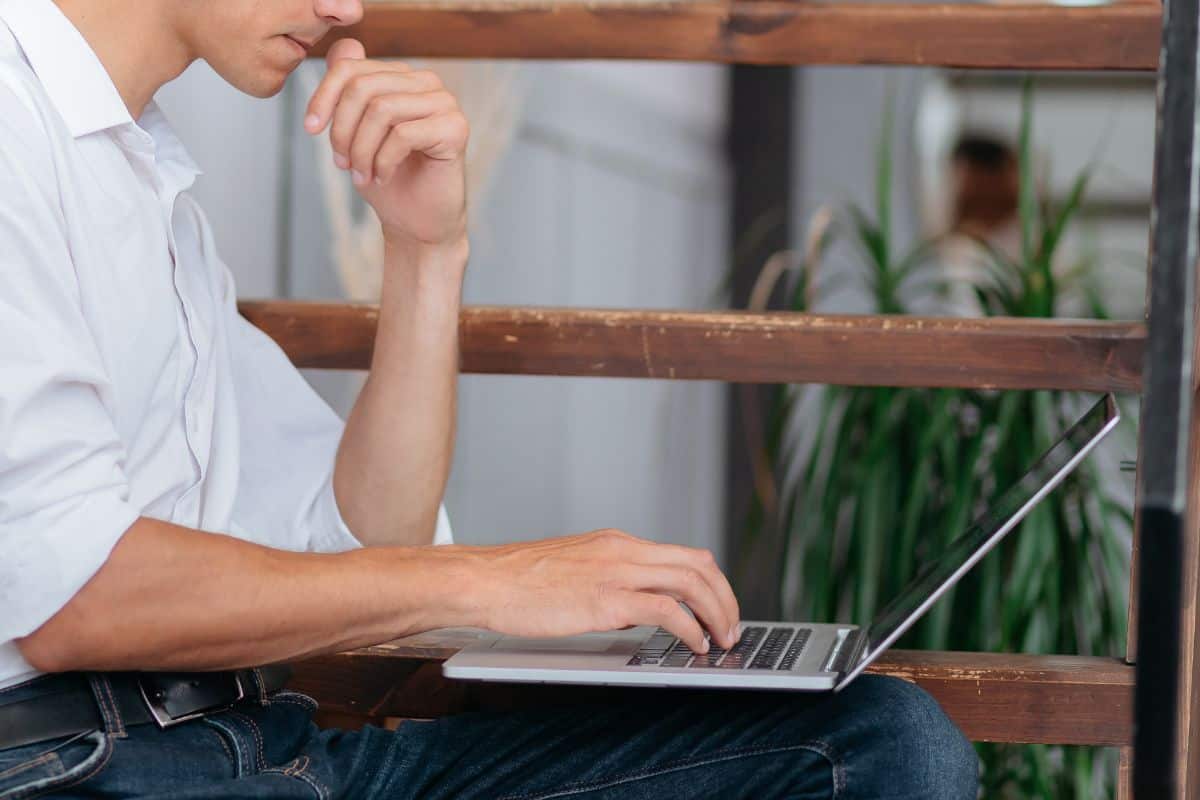 Young man resting at his house and using laptop