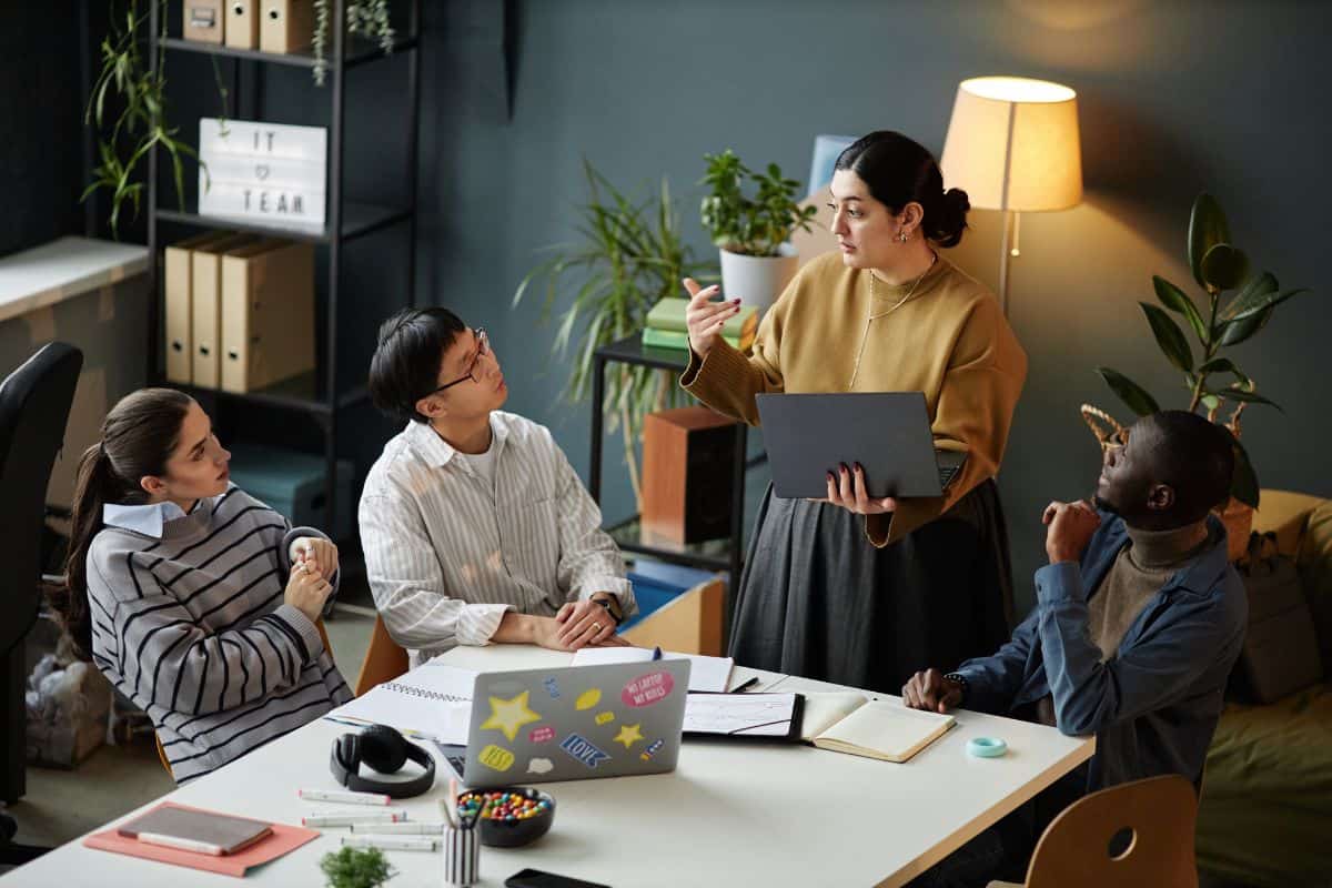 Woman presenting ideas to multiethnic team