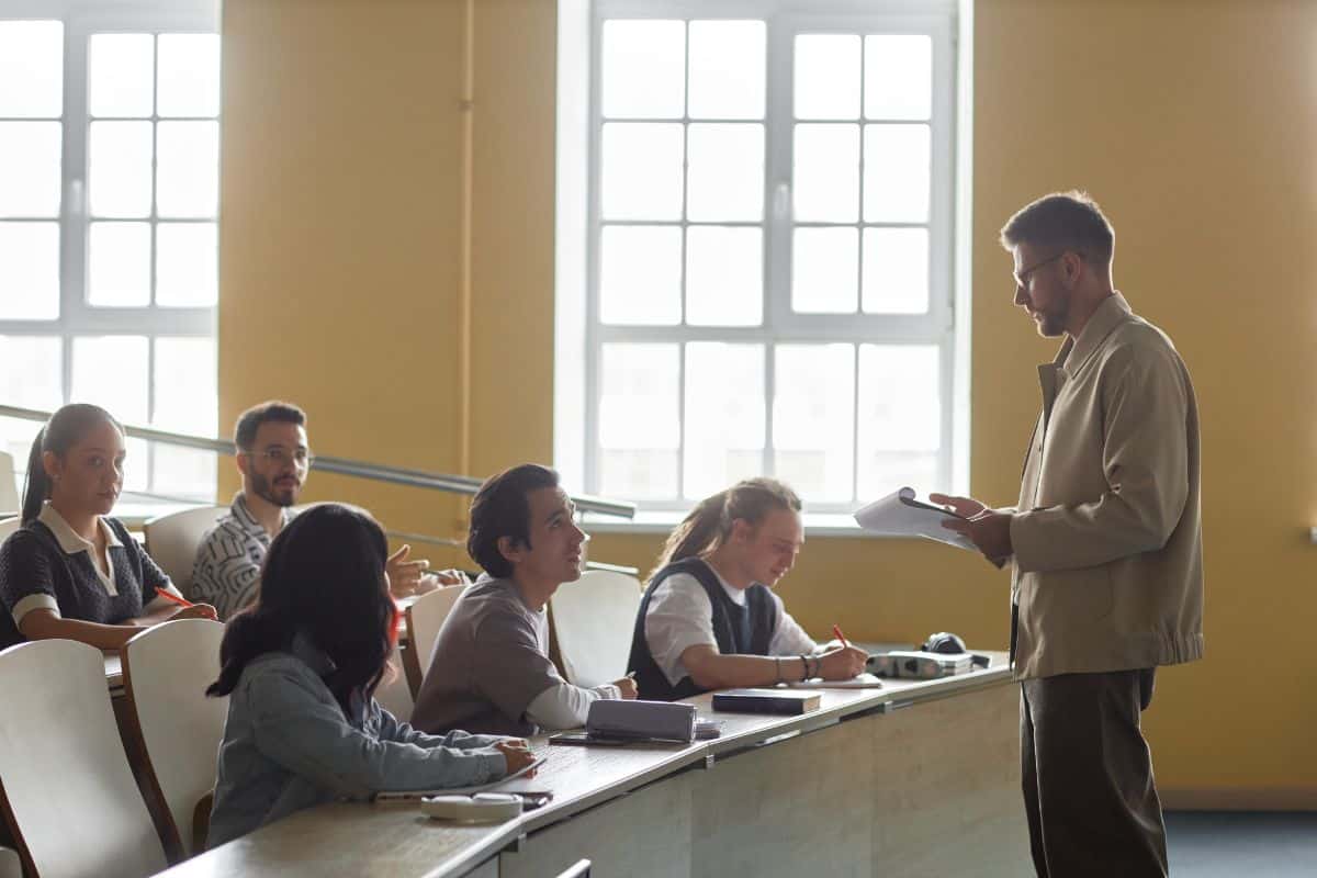 Male college teacher lecturing in classroom