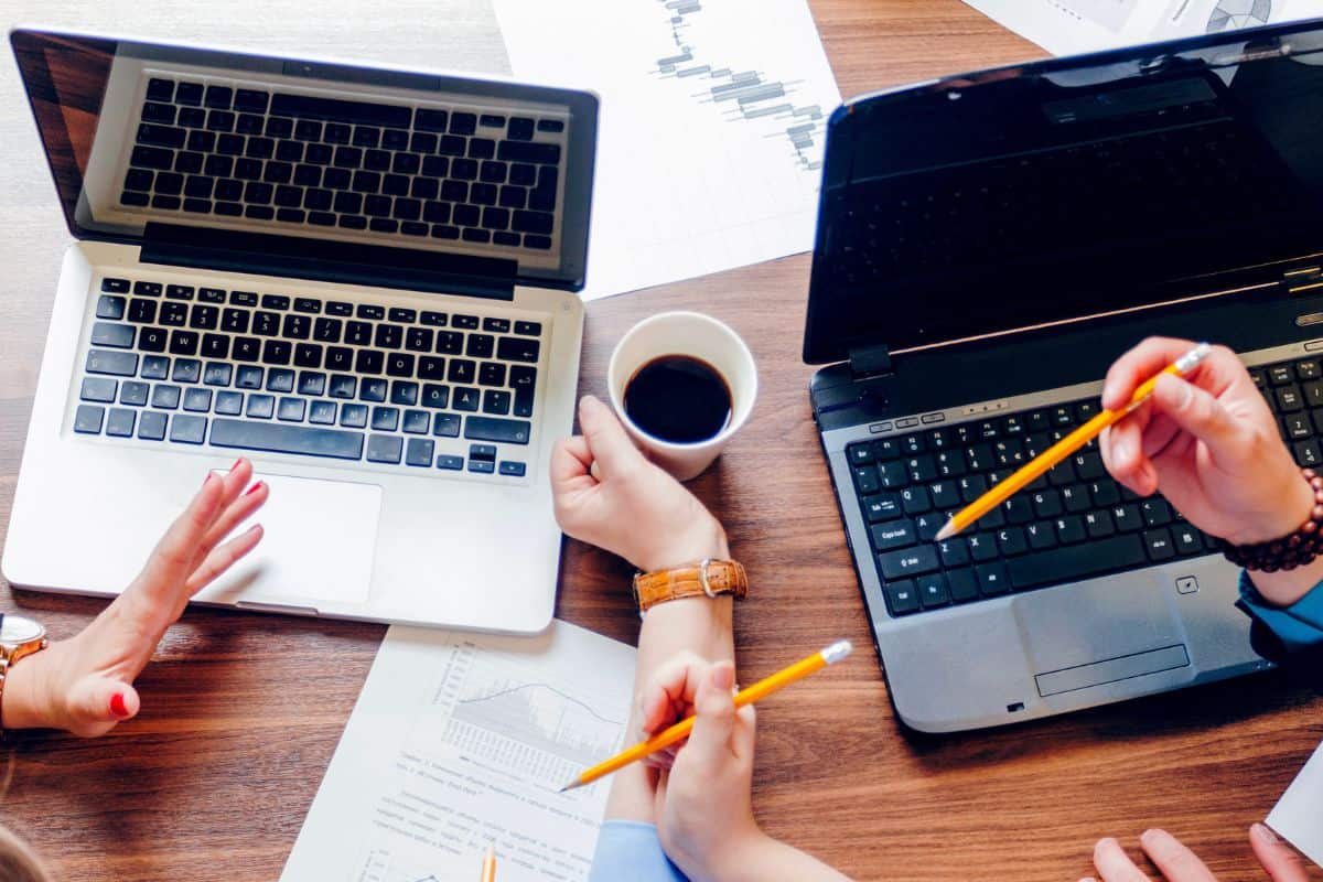 People sitting at desk with laptops working