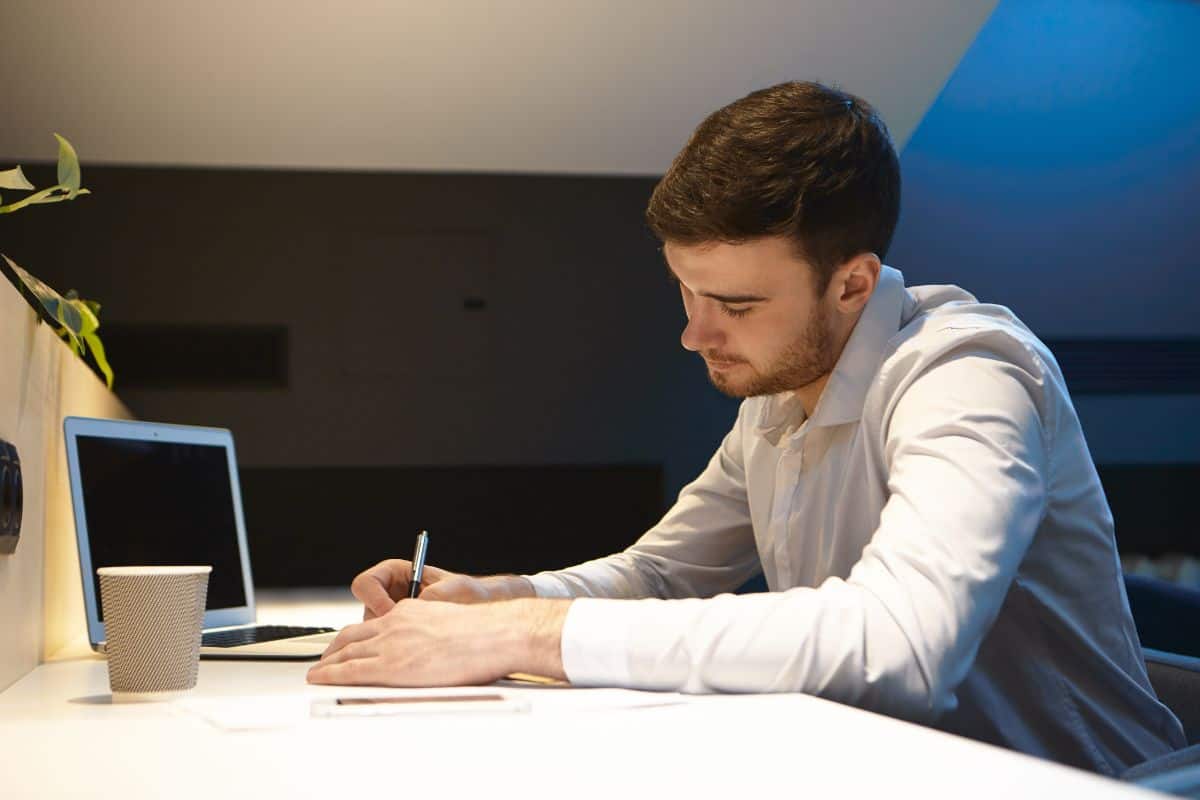 concentrated young caucasian creative male employee working in the office