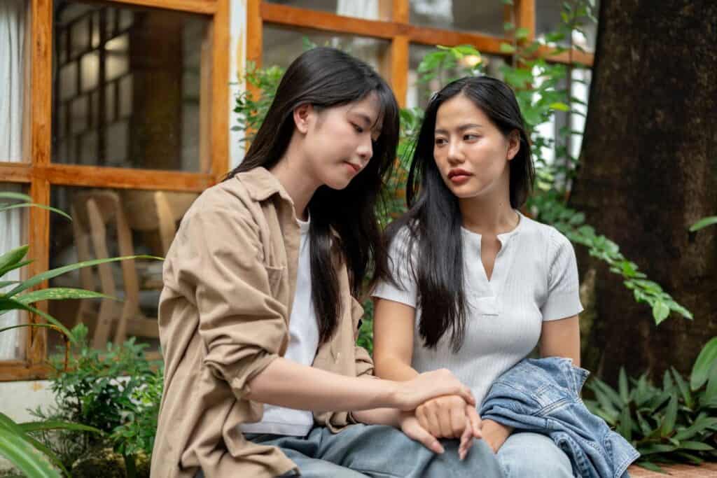 A caring woman is comforting and encouraging her sad friend