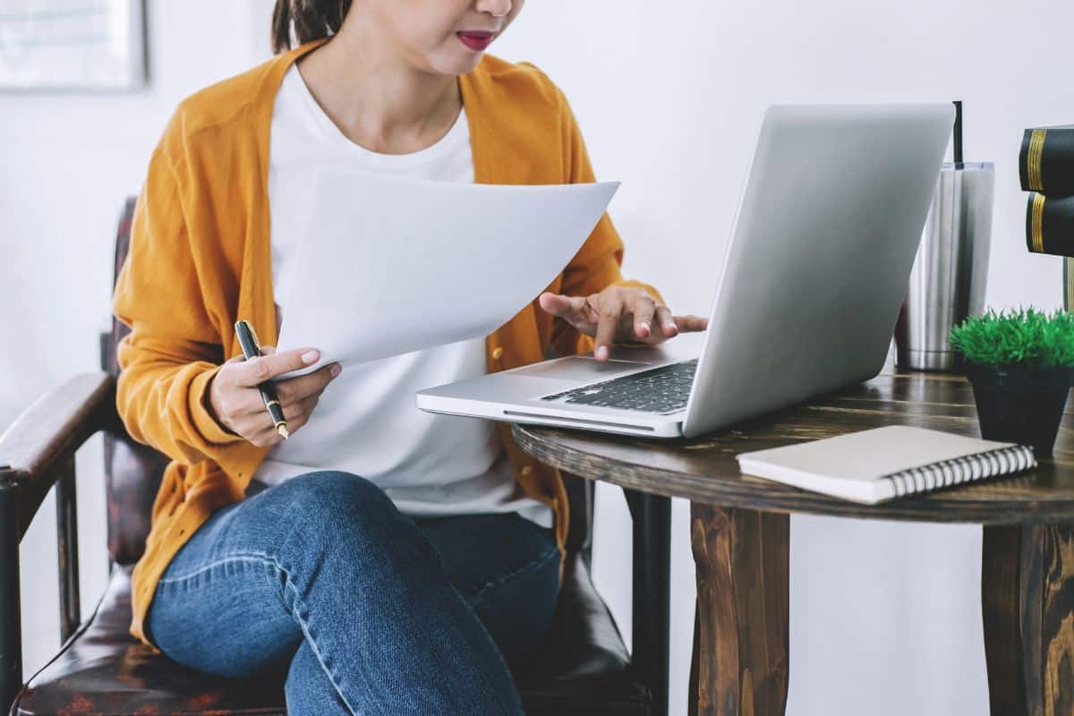 Midsection of businesswoman using laptop while working in office