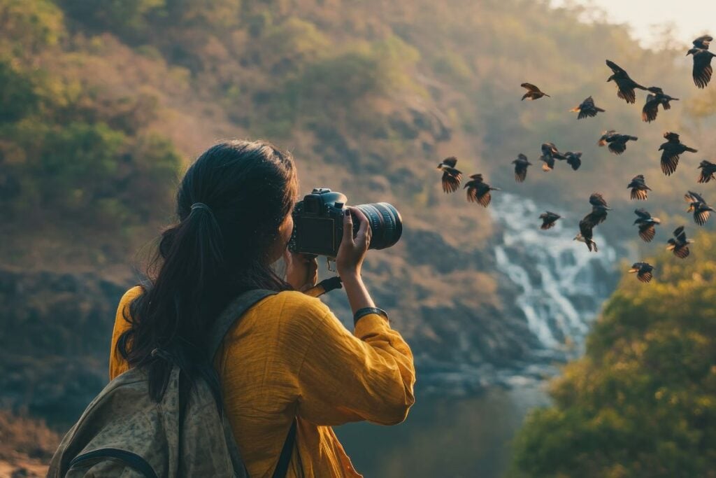 Woman capturing natures symphony in a breathtaking landscape