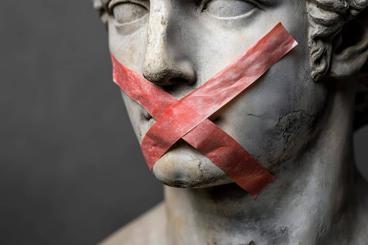 A red tape crossed over mouth of greek man