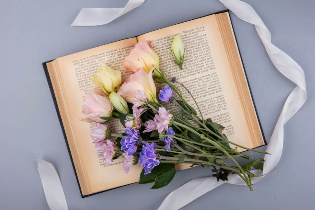 top view of fresh flowers with white ribbon isolated