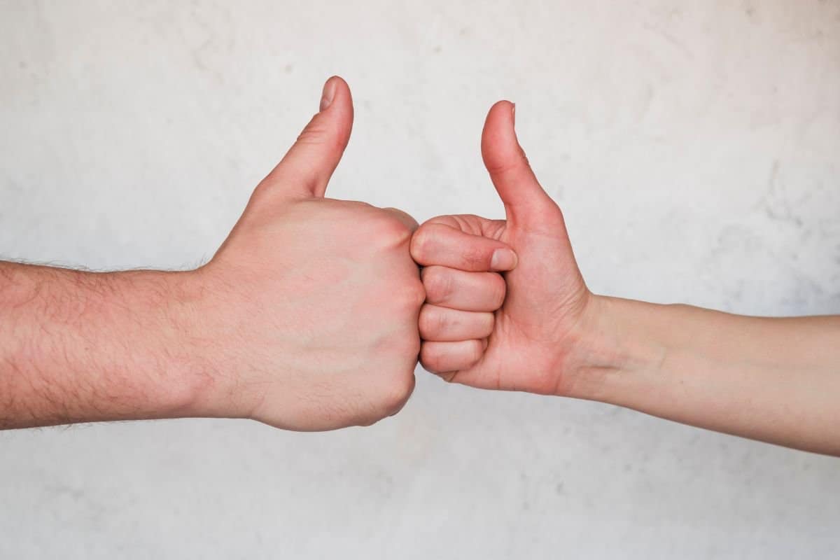 Hands showing thumb up sign