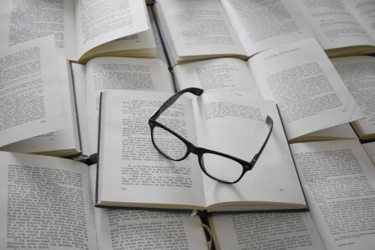 eyeglasses on top of open books