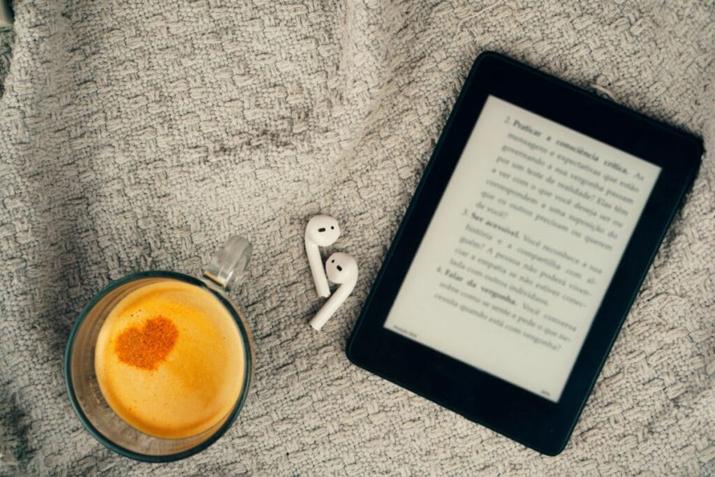 E-book reader, a cup of coffee and a earphone.