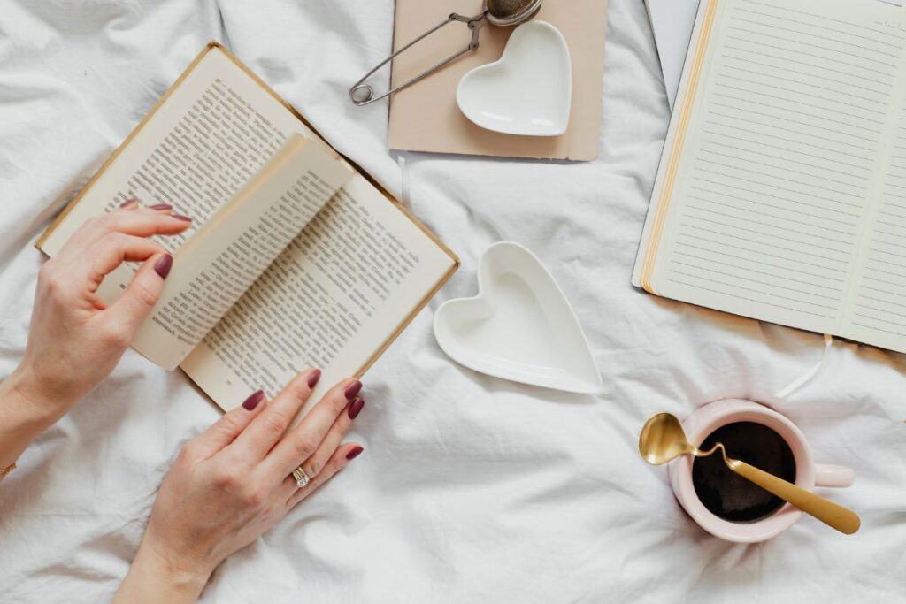 Woman reading a novel on her bed on a sunday afternoon