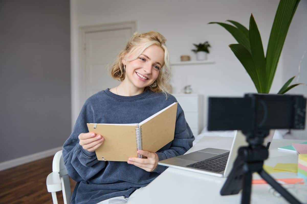 Portrait of cute young woman teenage girl records video