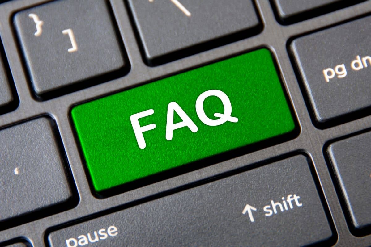 Frequently ask question concept laptop keyboard with green faq button