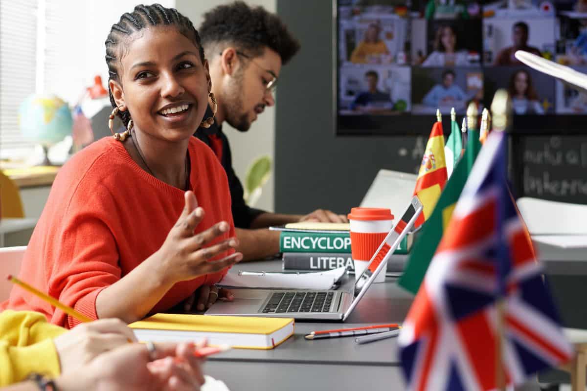 Vertical image of students sitting at international meeting in the classroom